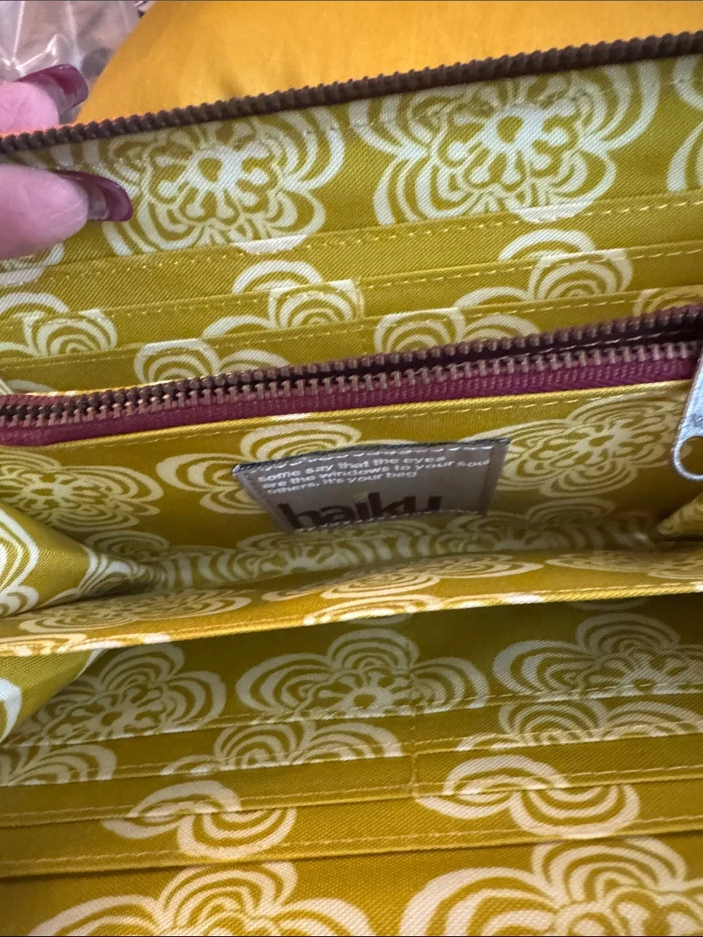 Haiku Orange Floral Embossed Wristlet with Chain Strap